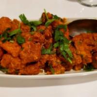 Chicken 65 · Boneless cubes of chicken marinated in corn flour batter with spices, deep fried and tossed ...