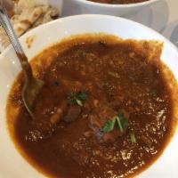Goat Curry · Cooked in a traditional Indian curry sauce.