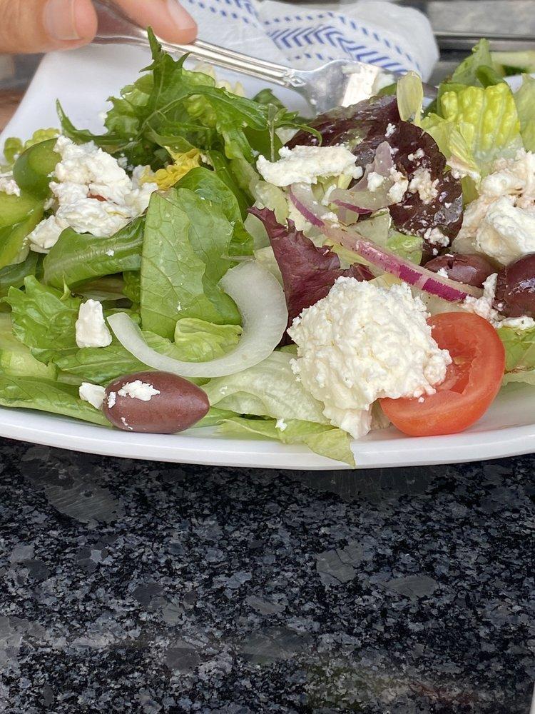 Greek Salad ·  Mixed garden style greens topped with feta cheese, stuffed grape leaves, Kalamata olives, red onions, peppers, cucumbers and tomatoes in our homemade Greek dressing. Gluten free. Add anchovies for an additional charge.