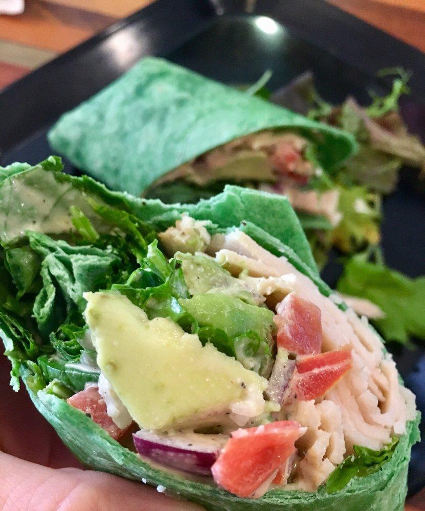 Spinach Turkey Caesar Wrap · Oven roasted turkey, spinach, tomato, avocado, Parmesan cheese, red onions, and Caesar dressing in spinach wrap.