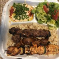 Combination Plate · 3 skewers of chicken, filet minion and khash khash kebab. Served with rice, hummus, salad an...