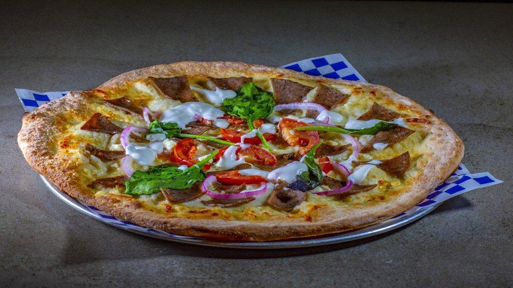 The Gyro Pizza · Lamb, beef, onions, tomato, spring mix, feta cheese, tzatziki sauce and olive oil.