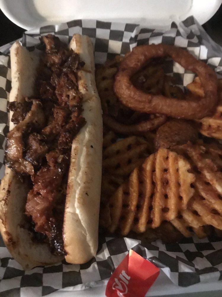 Pulled Pork Sandwich · Served with fries and onion rings.