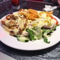 Chicken Souvlaki · Grilled marinated boneless chicken served on sliced pita with french fries and small Greek s...