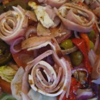 Antipasto Salad · Ham, salami and fresh mozzarella atop iceberg lettuce, tomatoes, cucumbers, onions, olives, ...