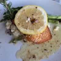 Grilled Salmon Caesar Salad · Atlantic Alaskan salmon on fresh romaine lettuce, croutons, Caesar dressing, topped with Par...