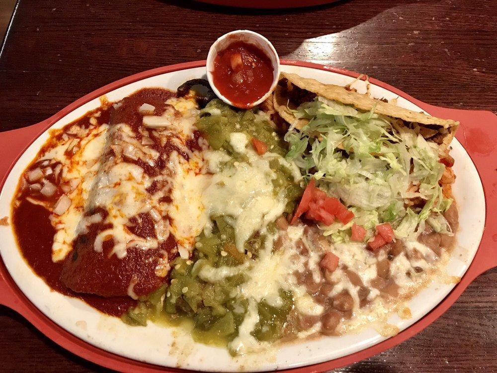 Tuesday Atrisco Plate · A relleno with green chile, a blue corn chicken enchilada with red chile, and a beef taco served with rice and beans.