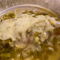Chile Rellenos · Two New Mexican chiles stuffed with cheese, covered with a bread crumb batter and served wit...