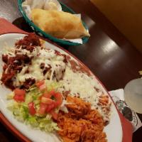 Carne Adovada · Marinated pork in a spicy red chile sauce, baked in the oven and covered with cheese. Served...