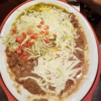 Huevos Rancheros · Two fresh eggs on a corn tortilla, topped with cheese and your choice of chile, served with ...