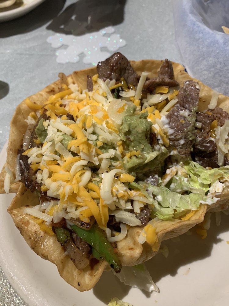 Fajita Salad · Lettuce topped with your choice of fajita (beef or chicken) lightly sprinkled with cheese, guacamole, and sour cream on a flour tortilla shell.