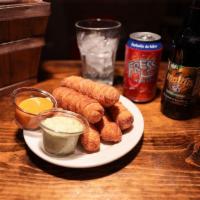 Tequenos · Fried wheat flour cheese sticks with garlic and fancy sauce.