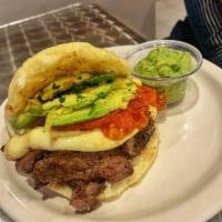 Cowboy Arepa · NY strip Angus beef strips, avocado, tomatoes and white cheese.