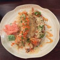 Terry Roll · Shrimp tempura and avocado inside, topped with fresh salmon, spicy tuna, crunchy flakes, mas...