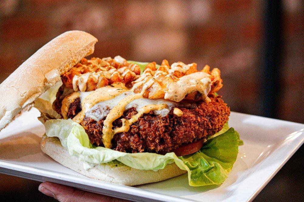 Beer Battered Burger · Harris ranch ½ lb. beef patty deep-fried in craft beer batter, Swiss cheese, citrus jalapeno aioli, lettuce, tomato, topped with waffle fries and spicy ranch.