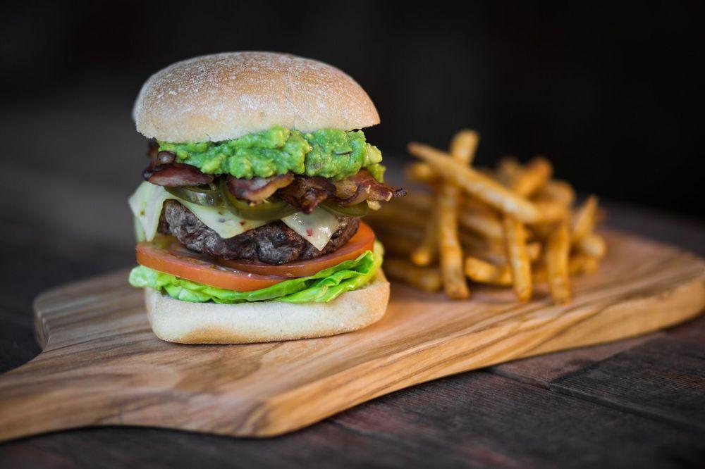 Spicy Guacamole Burger · Guacamole, Applewood smoked bacon, pickled jalapenos, pepper jack, citrus jalapeno aioli, lettuce and tomato.