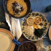 Feijoada · Black beans with smoked pork, sausage, dry beef stew, collard greens, roasted yucca flour, o...