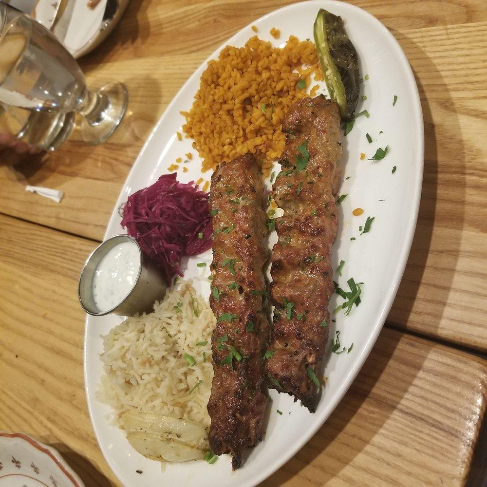 Adana Kebab · Hand diced lamb flavored with fresh red bell peppers, gently spiced with paprika and grilled on skewers. Served with rice and burgol.