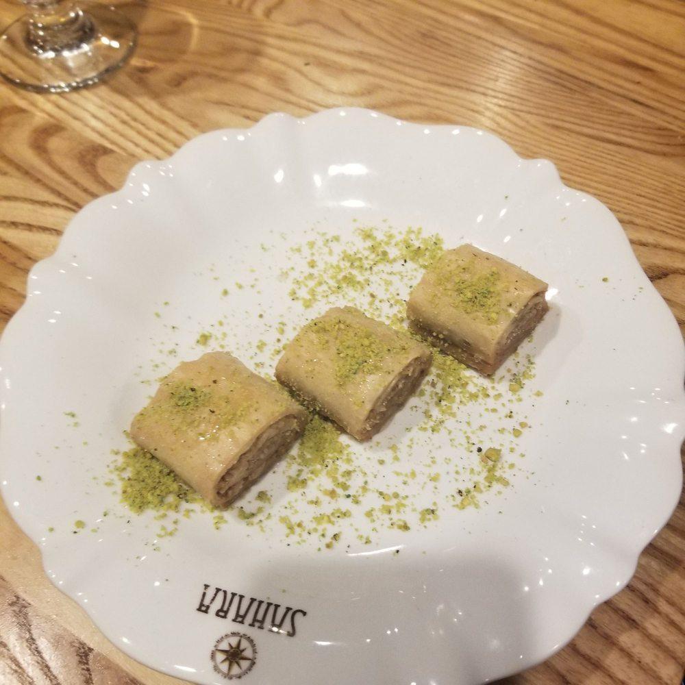 Baklava · Sweet pastry of layers of phyllo dough filled with crushed walnuts and topped with honey syrup and pistachios.