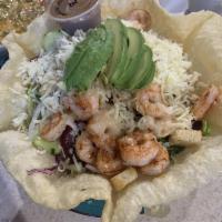 Shrimp and Avocado Salad · A giant, crisp flour tortilla bowl filled with lettuce and topped
with shrimp, avocado wedge...