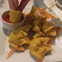 Crab Rangoon · A delicious blend of crabmeat with cream cheese seasoned served with wonton sheet & crisp.