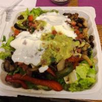 Fajita Salad · Grilled peppers and onions, lettuce, cheese, guacamole, sour cream and salsa.