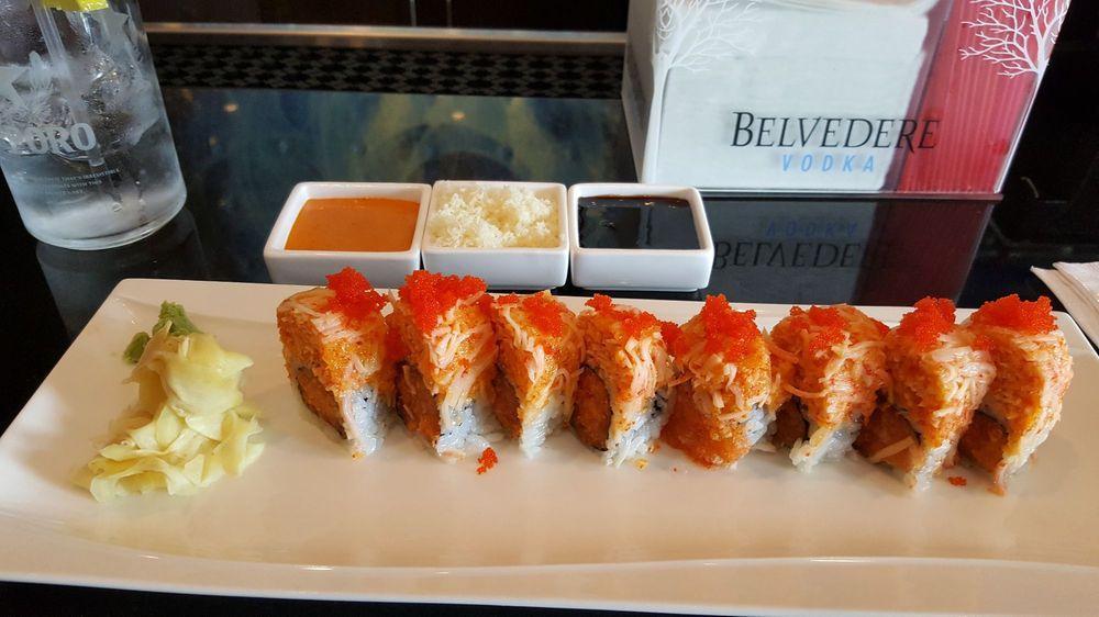 Dynamite Roll · In: spicy salmon and tempura flake. Top: with spicy crab and tobiko.