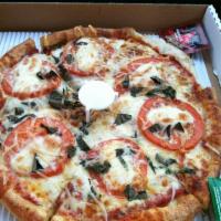 Margherita Pizza · Fresh basil, oregano, fresh garlic, tomatoes, Parmesan and mozzarella cheese.