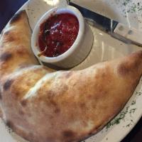 Calzone · Folded stuffed pizza made with ricotta or mozzarella and pomarola sauce.