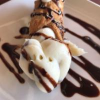 Cannoli · A tube-shaped shell of fried pastry dough, filled with a sweet, creamy filling containing ri...