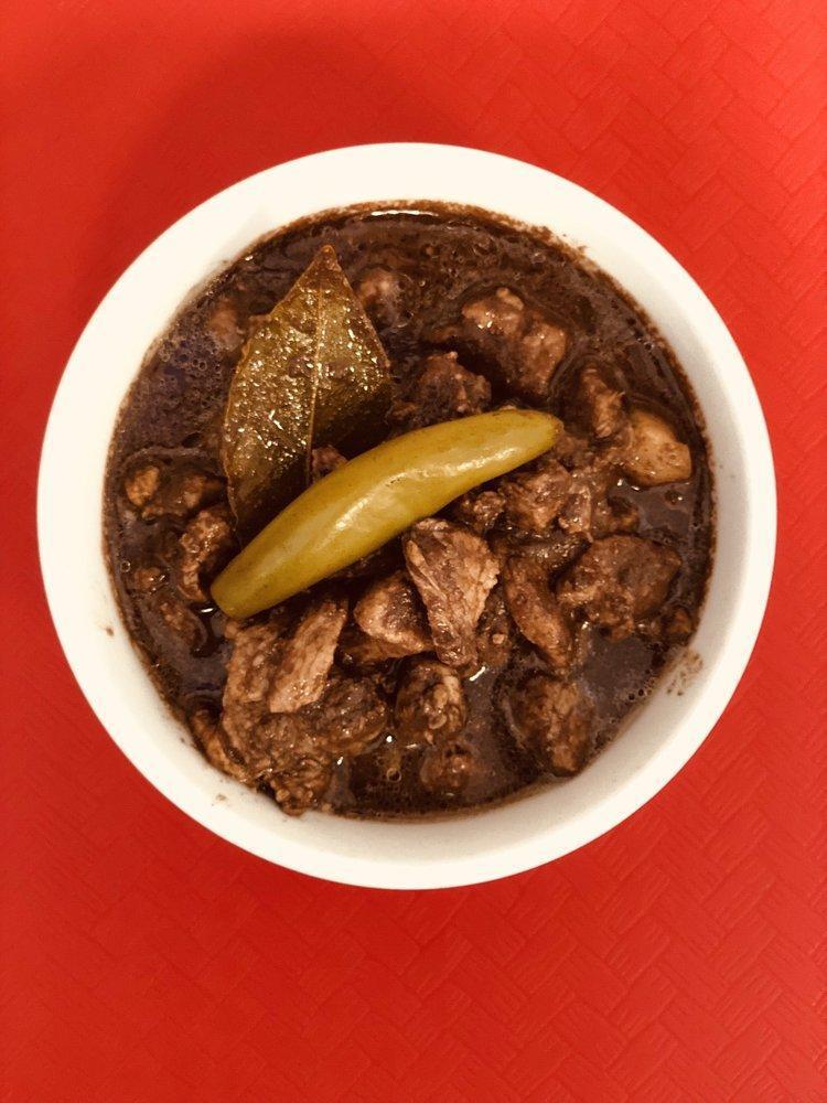 Dinuguan · An authentic  Filipino cuisine. Dinuguan is a Filipino savory stew made  of pork  meat and pork buche simmered in a rich, spicy dark gravy of pork blood, garlic, and vinegar. 