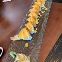 Fantasy Roll Signature Rolls · Shrimp tempura, avocado, lobster salad inside mango on top with mango sauce.