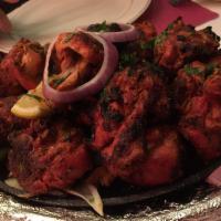 Tandoori Chicken · Chicken on the bone, marinated overnight in clay tandoor oven. Served with aromatic basmati ...