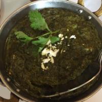 Saag Paneer · Fresh farmers cheese cooked in a flavorful spinach curry. Served with aromatic basmati rice.
