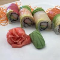 Rainbow Roll · Inside: crab meat, avocado, and cucumber. Top: sliced avocado and assorted sashimi.  