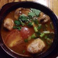 Tom Yum Soup · Hot and sour soup with straw mushrooms, tomatoes, lemon grass, citrus leaves and fresh lime ...