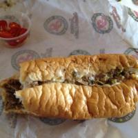 Baja Cheesesteak · Choice of steak or chicken, grilled onions, jalapenos and American cheese.