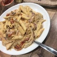 Roma's Spicy Chicken and Shrimp · Chicken, shrimp, mushrooms, sun-dried tomatoes, onions and penne pasta with spicy Alfredo sa...