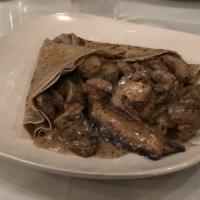 Mushroom Medley Crepe · Assorted mushrooms sauteed in a white wine and garlic cream sauce wrapped in a buckwheat cre...