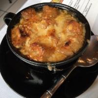 French Onion Soup · Topped with gruyere cheese and toasted until golden and bubbly.