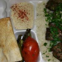 Beef Kabob Plate · Marinated pieces of beef. Served with hummus, grilled green pepper and tomato, choice of ric...