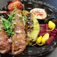 Beef Lule Kabob Plate · Seasoned ground beef. Served with hummus, grilled green pepper and tomato, choice of rice or...