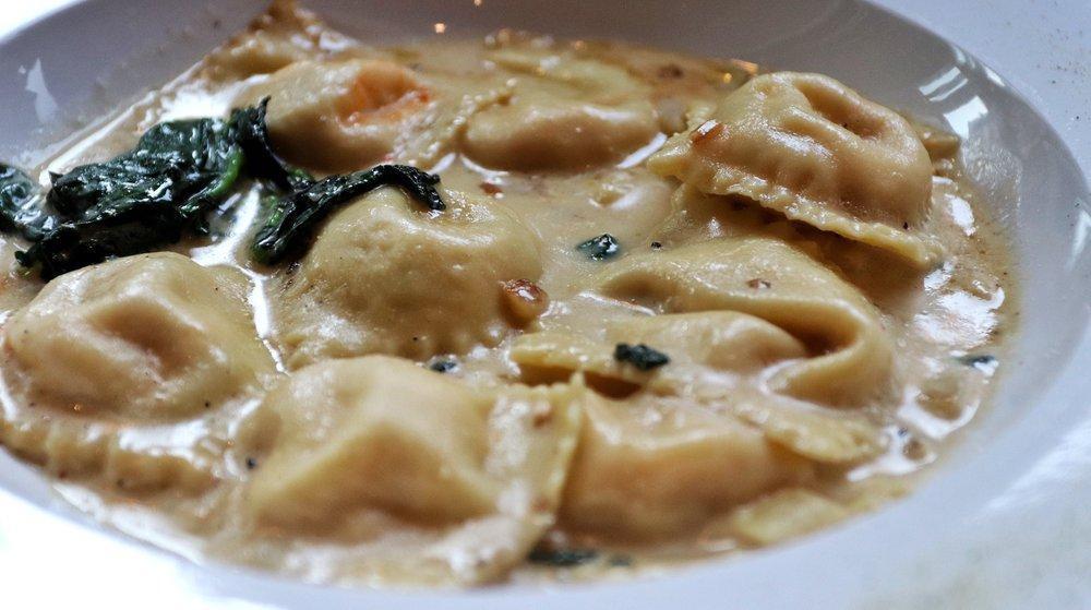 Lobster Ravioli · Filled with fresh lobster meat, served in a mascarpone lobster veloute garnished with spinach.