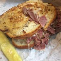 The Reuben Sandwich · 1/3 lb.  Corned beef, or turkey, or pastrami served grilled on rye with kraut, Swiss and 100...