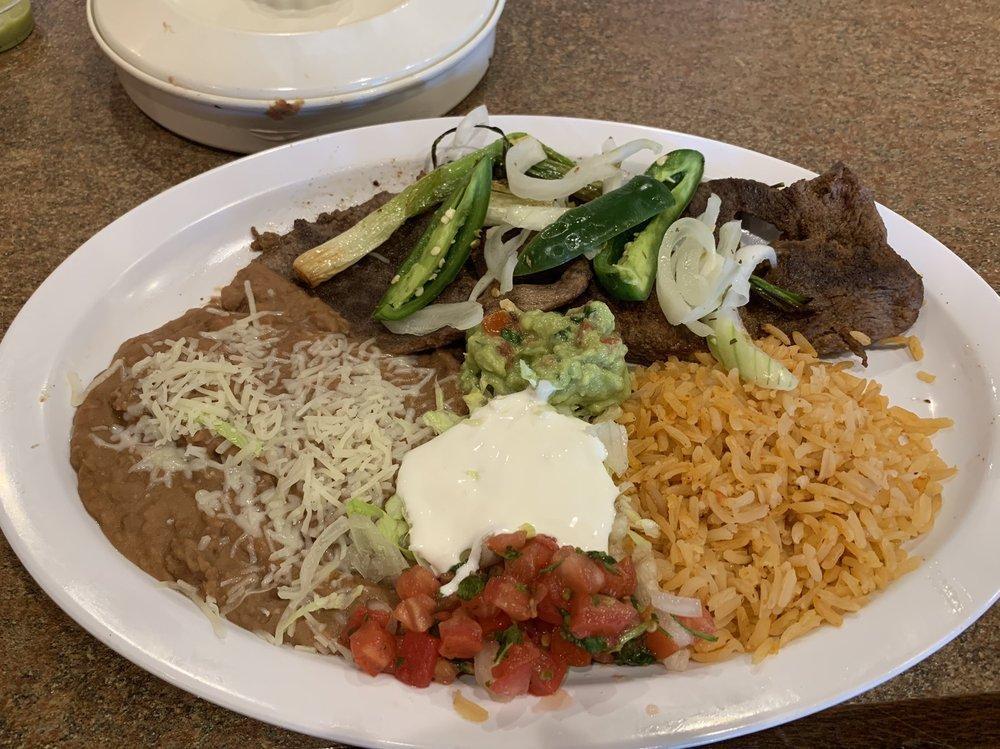 Carne Asada Platter · Seasoned and grilled steak, accompanied by Spanish rice, beans, sour cream, salsa fresca, guacamole and your choice of tortillas.