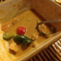 Panang Curry · Rich thick panang curry with coconut milk, bell peppers, tomatoes, onion and ground peanut.