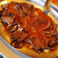 Iskender Kebab · Thinly sliced vertically grilled lamb served with yogurt and tomato garlic. 