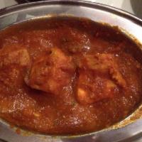 Chicken Curry · Boneless chicken cooked with fresh onions, garlic and unique blend of spices. Served with ba...