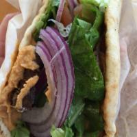 The Classic Gyro Wrap · Rotisserie style roasted lamb and beef wrapped in pita bread, topped with lettuce, tomatoes,...