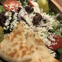 Modern Greek Salad · Lettuce medley, feta cheese, Greek olives, sliced pepperoncini, tomato, cucumber, housemade ...